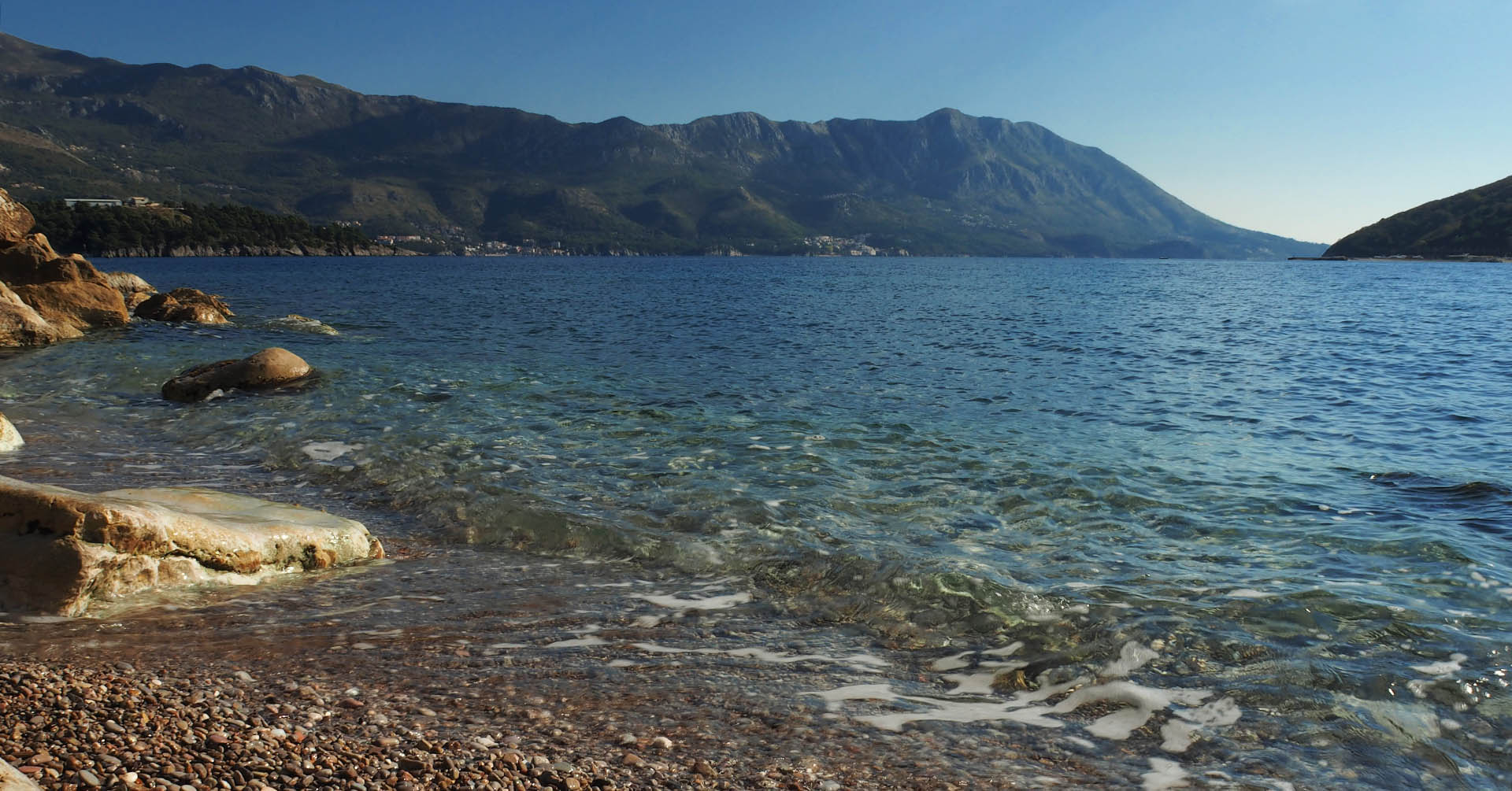 Pebble beach in Montenegro with crystal-clear water